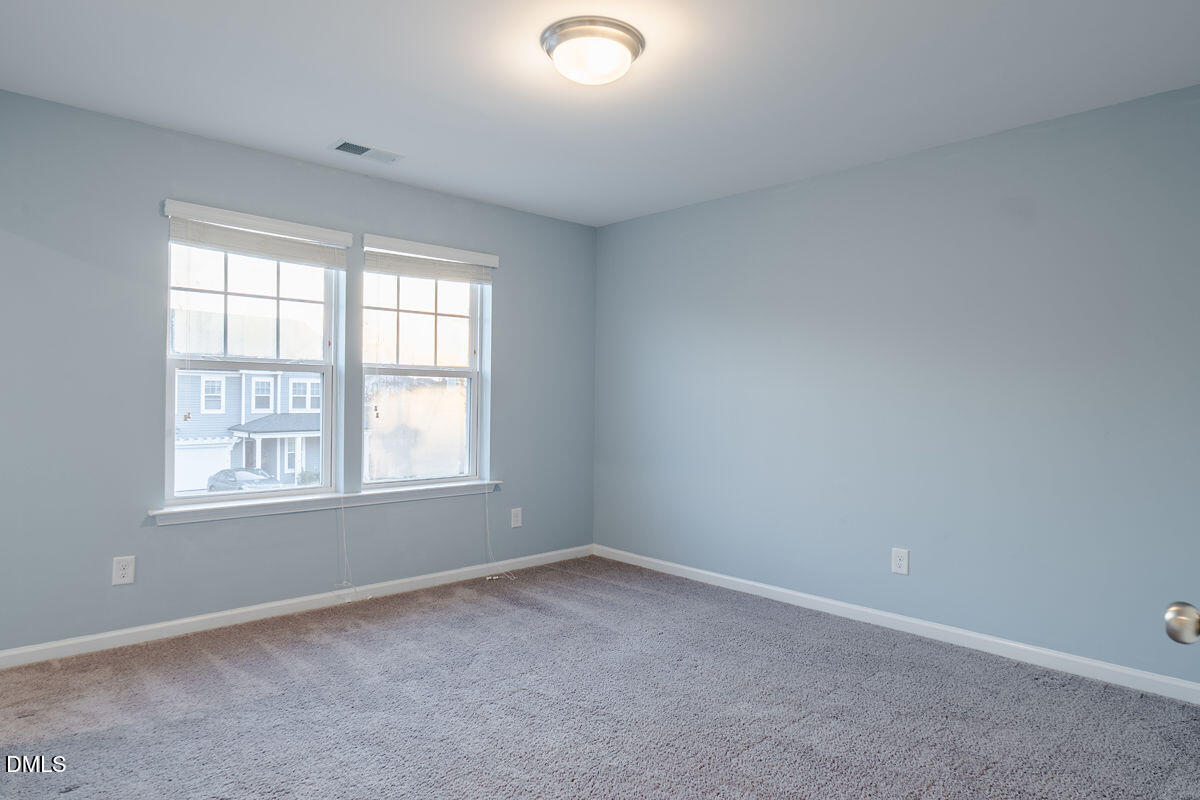 87 East Ravano Drive Clayton, NC 27527 - Photo 28 of 37 an empty room with a window