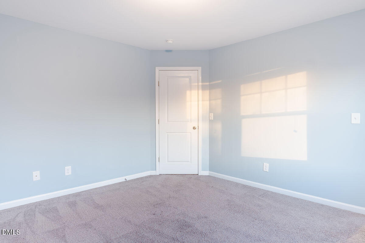 87 East Ravano Drive Clayton, NC 27527 - Photo 31 of 37 an empty room with windows and closet