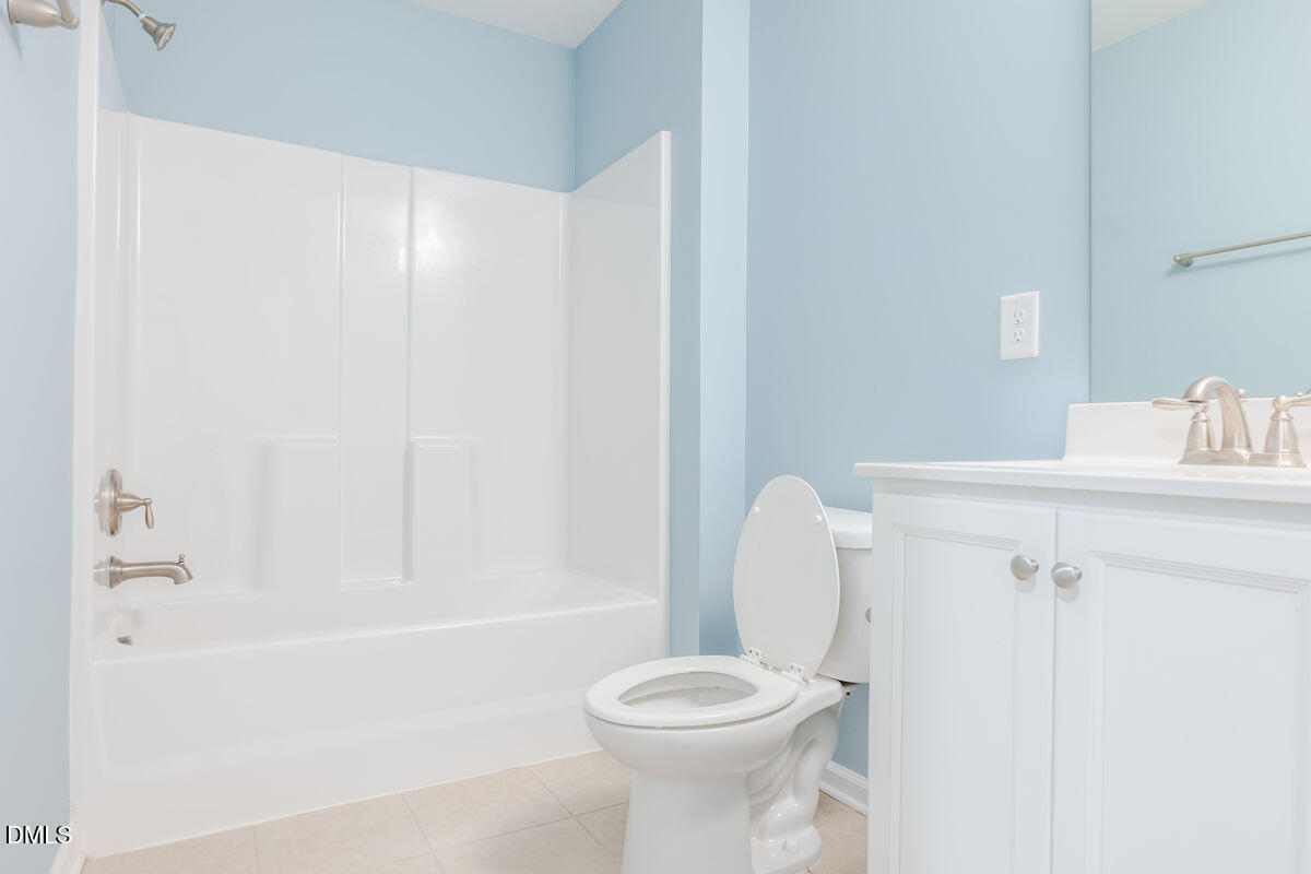 87 East Ravano Drive Clayton, NC 27527 - Photo 32 of 37 a bathroom with a toilet and a bathtub