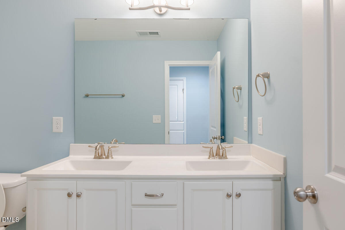 87 East Ravano Drive Clayton, NC 27527 - Photo 33 of 37 a bathroom with a sink and a mirror