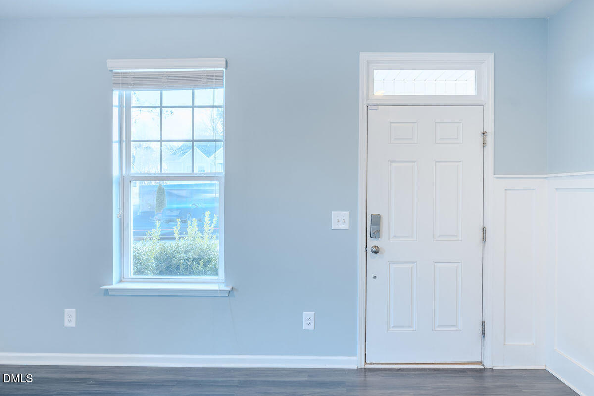 87 East Ravano Drive Clayton, NC 27527 - Photo 4 of 37 an empty room with wooden floor closet and windows