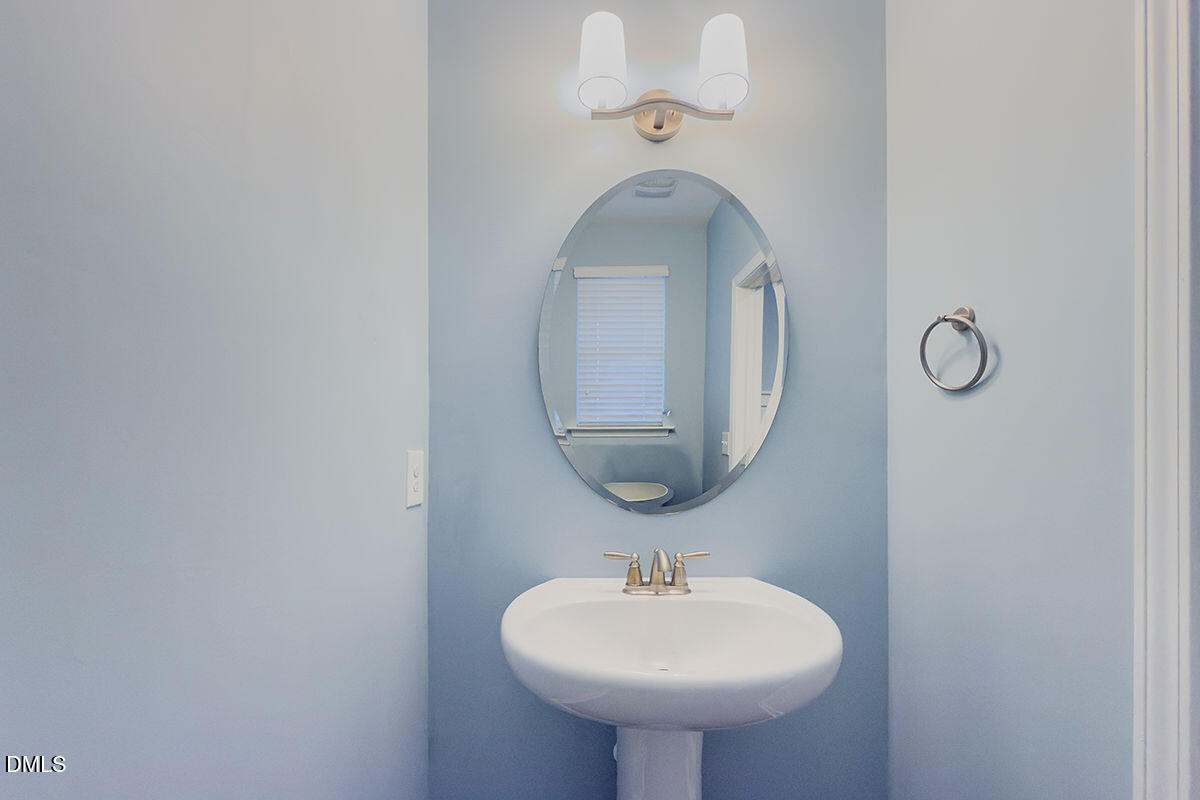 87 East Ravano Drive Clayton, NC 27527 - Photo 6 of 37 a bathroom with a sink and a mirror
