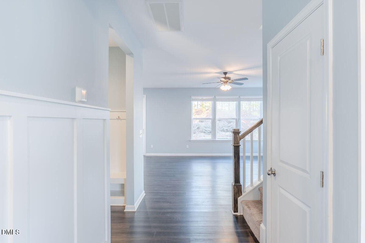 87 East Ravano Drive Clayton, NC 27527 - Photo 8 of 37 a view of a hallway with wooden floor and front door