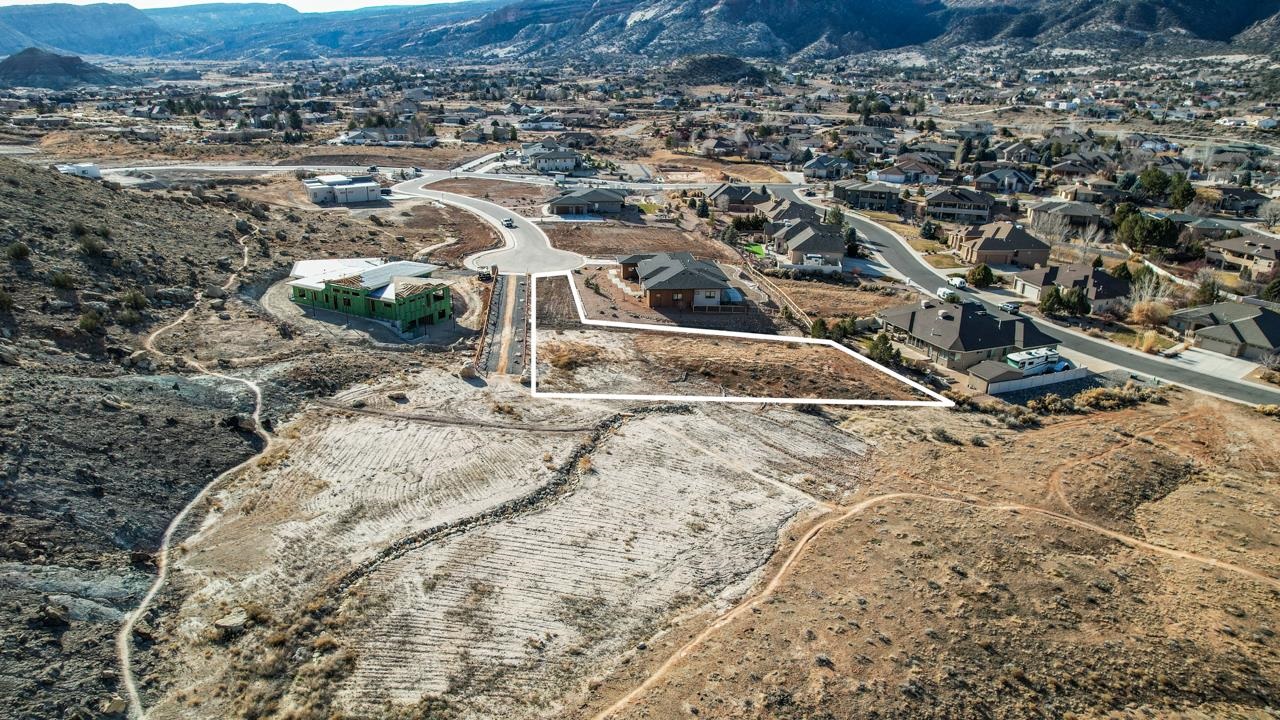 359 Canyon Rim Trail Grand Junction, CO 81507 - Photo 1 of 18 a view of a dry yard with wooden fence
