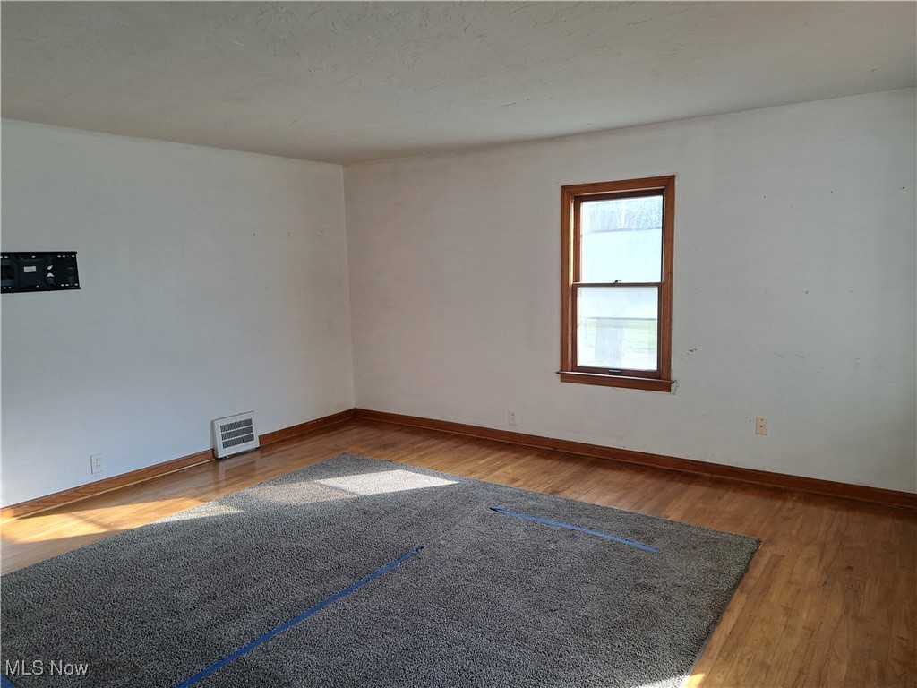 2245 North Ridge Road Lorain, OH 44055 - Photo 6 of 24 Empty room with wood-type flooring