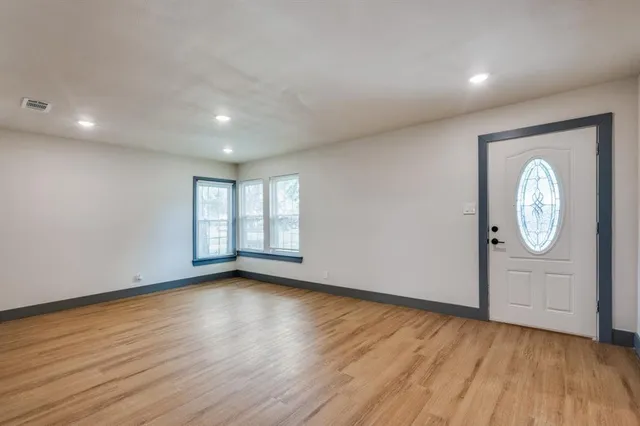 a view of room with window and wooden floor