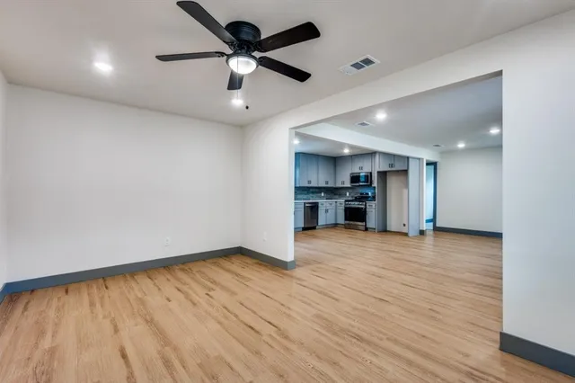 a view of an empty room with a kitchen