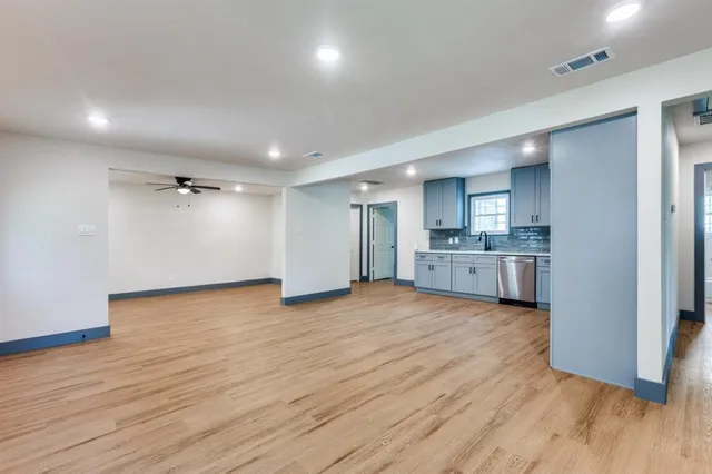 a view of a kitchen with wooden floor and a sink