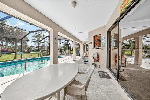 a living room with large windows and a table