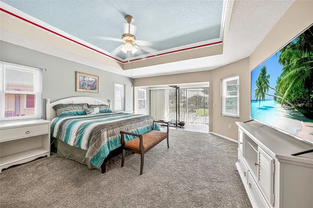 a spacious bedroom with a bed and a chandelier