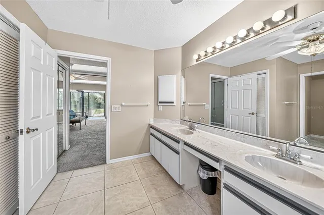 a spacious bathroom with a double vanity sink a mirror and a shower