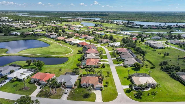 an aerial view of residential houses with outdoor space and swimming pool