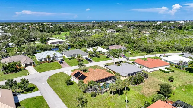 an aerial view of a residential houses with outdoor space and swimming pool