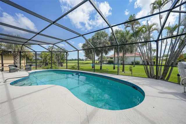 a view of a backyard with swimming pool