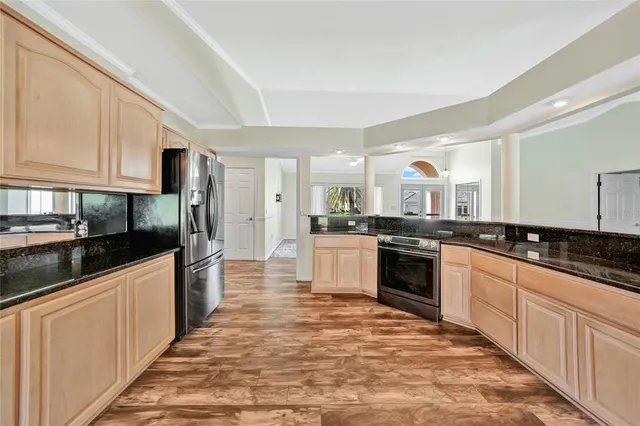 a large kitchen with stainless steel appliances and cabinets