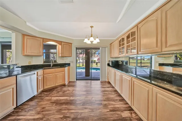 a large kitchen with stainless steel appliances granite countertop a stove and cabinets