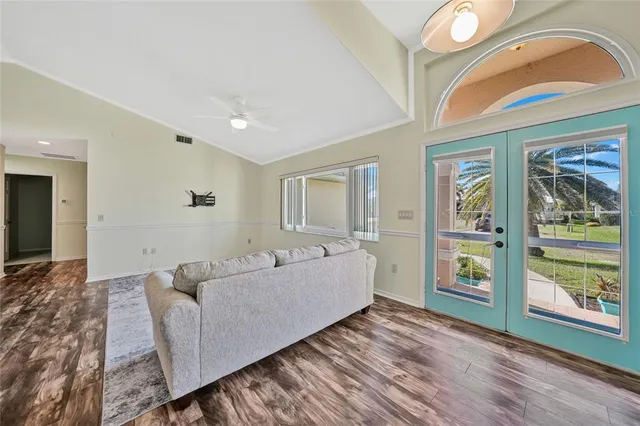 a living room with furniture and large window