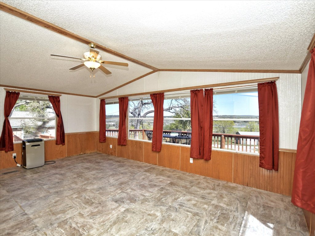 223 Golf Course Drive Spicewood, TX 78669 - Photo 12 of 38 wooden floor in an empty room with a window