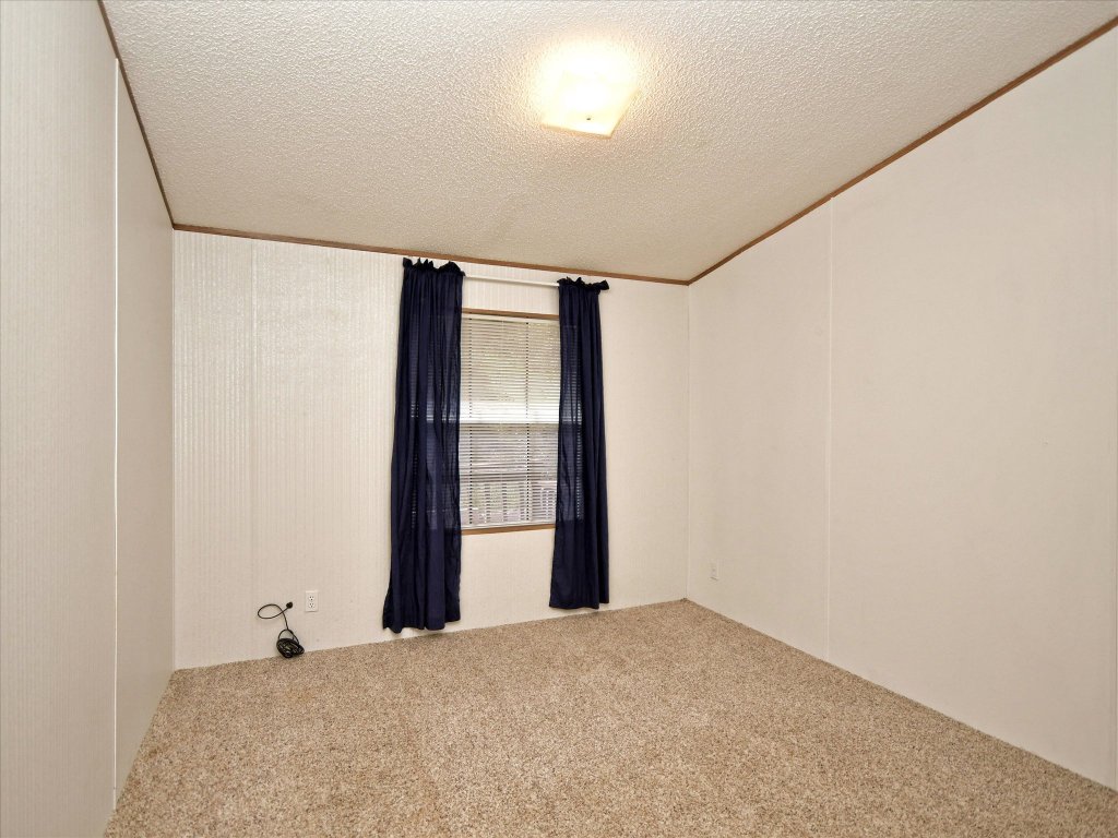 223 Golf Course Drive Spicewood, TX 78669 - Photo 15 of 38 a view of an empty room with a window