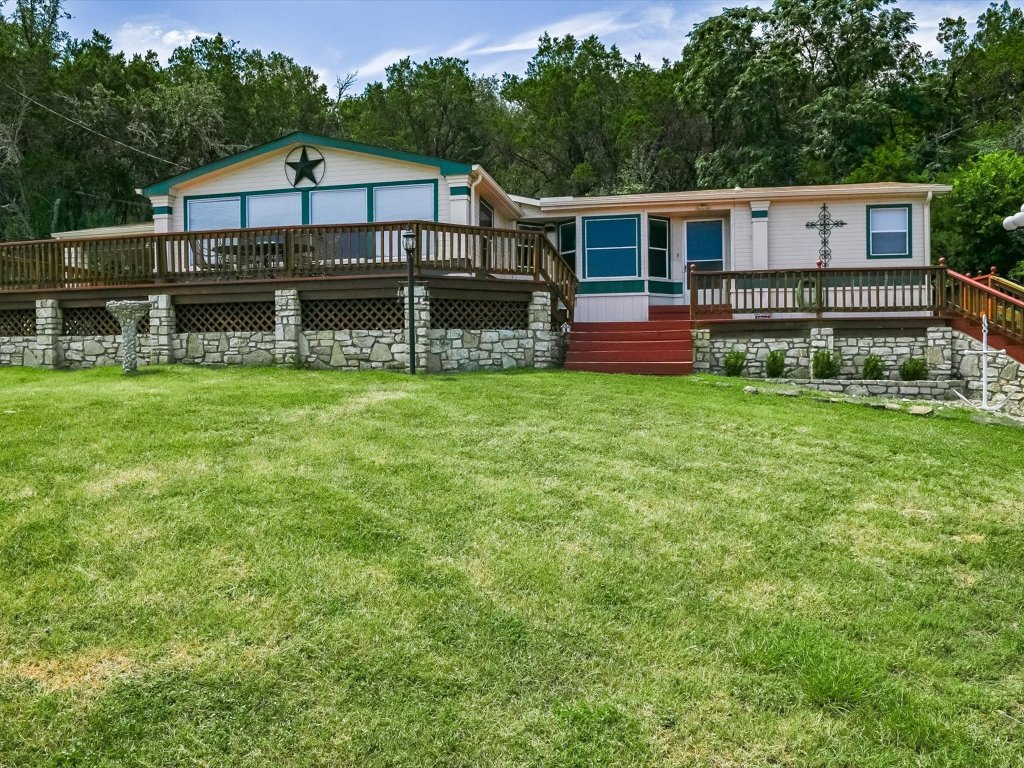 223 Golf Course Drive Spicewood, TX 78669 - Photo 2 of 38 front view of a house with a yard