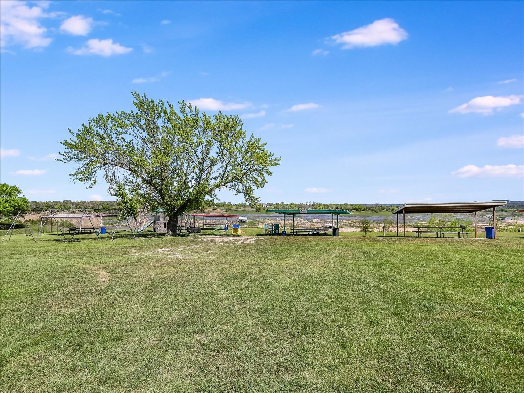 223 Golf Course Drive Spicewood, TX 78669 - Photo 26 of 38 a view of a field with an trees