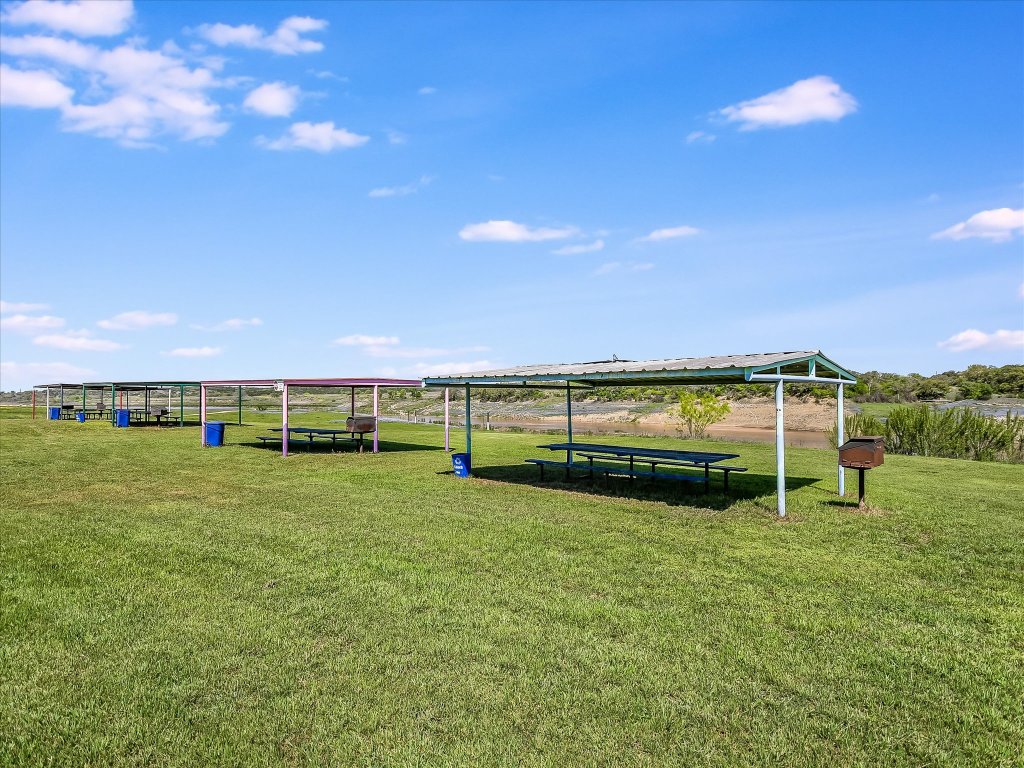 223 Golf Course Drive Spicewood, TX 78669 - Photo 27 of 38 a view of a golf course with a lake