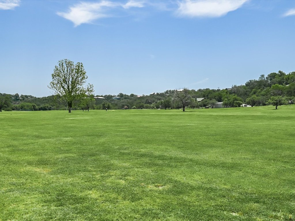 223 Golf Course Drive Spicewood, TX 78669 - Photo 34 of 38 a view of a grassy field with trees