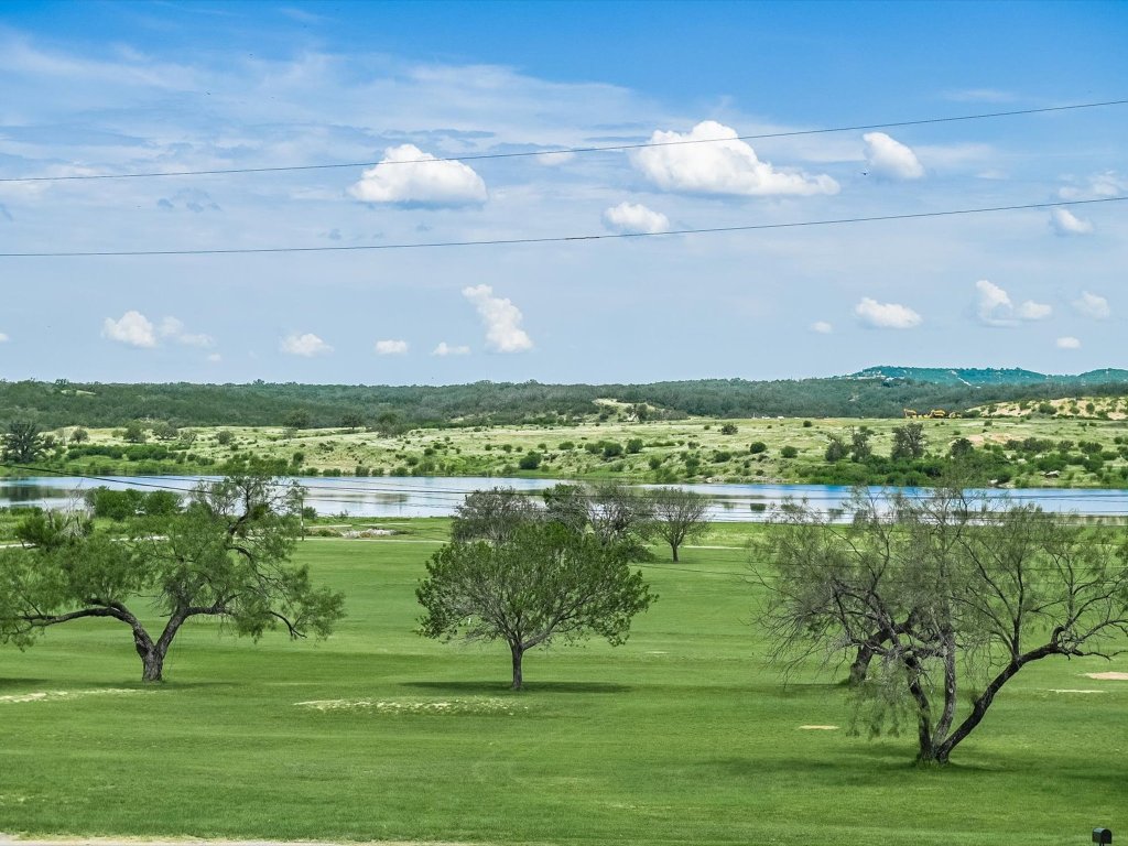 223 Golf Course Drive Spicewood, TX 78669 - Photo 38 of 38 a view of a lake with a big yard