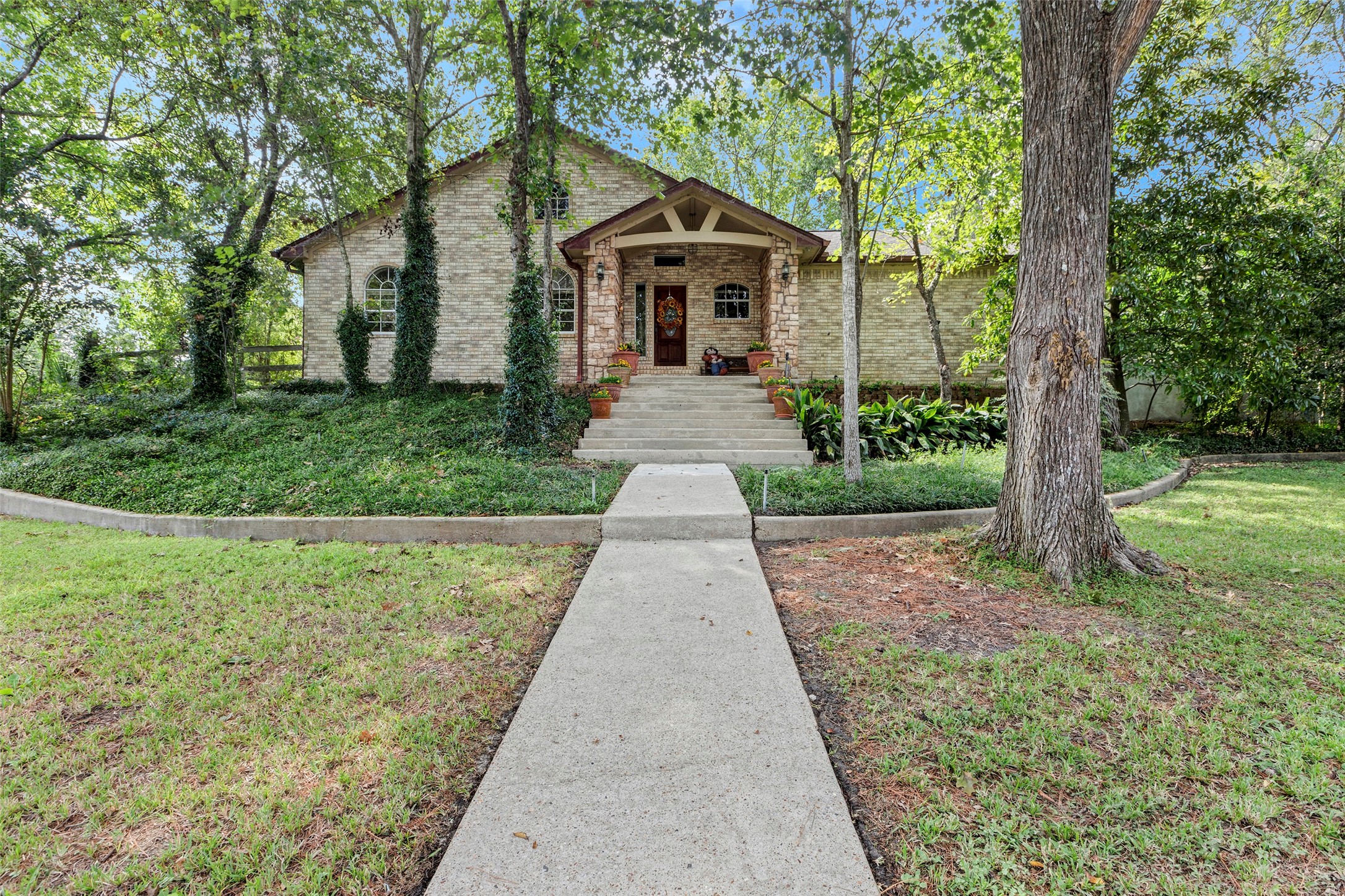 281 Harbor Run Drive Coldspring, TX 77331 - Photo 1 of 31 a front view of a house with yard