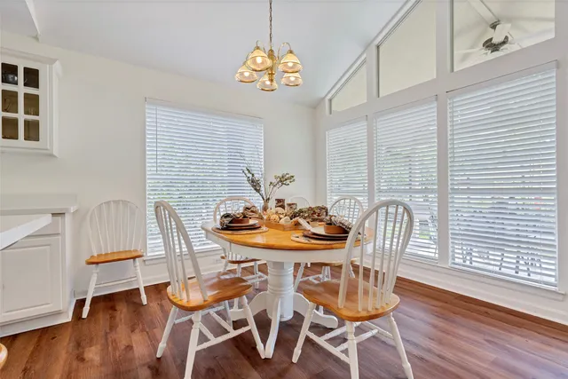 a view of a dining room with furniture and wooden floor