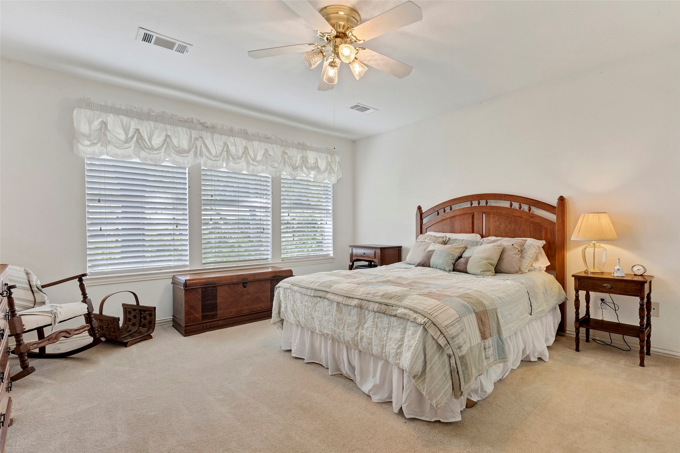 281 Harbor Run Drive Coldspring, TX 77331 - Photo 17 of 31 a bedroom with a bed and a chandelier