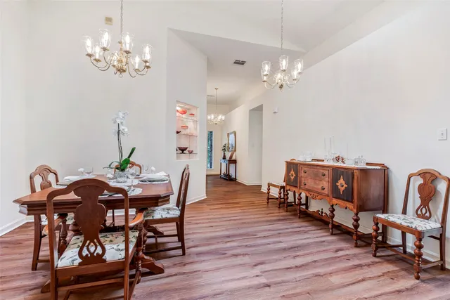 a view of a dining room with furniture and wooden floor