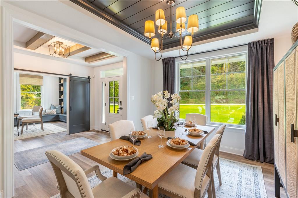 5136 Cline Hollow Road Export, PA 15632 - Photo 12 of 25 a view of a dining room with furniture a chandelier and wooden floor