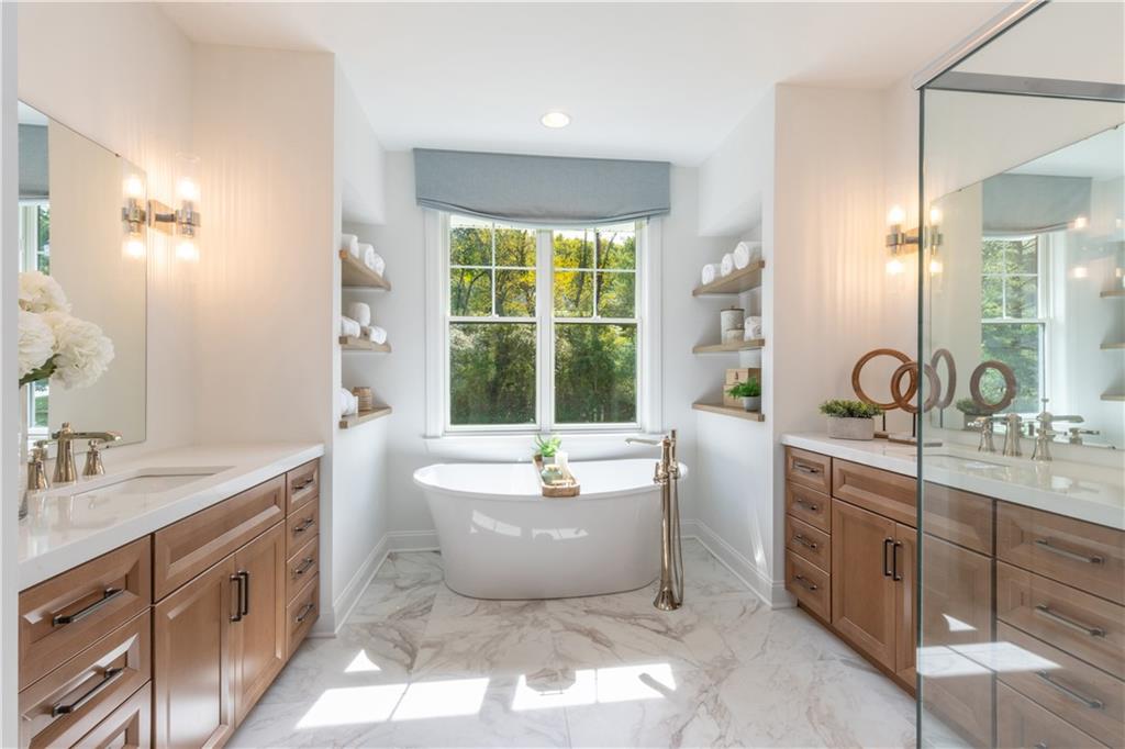 5136 Cline Hollow Road Export, PA 15632 - Photo 16 of 25 a spacious bathroom with a double vanity sink large mirror and a bathtub