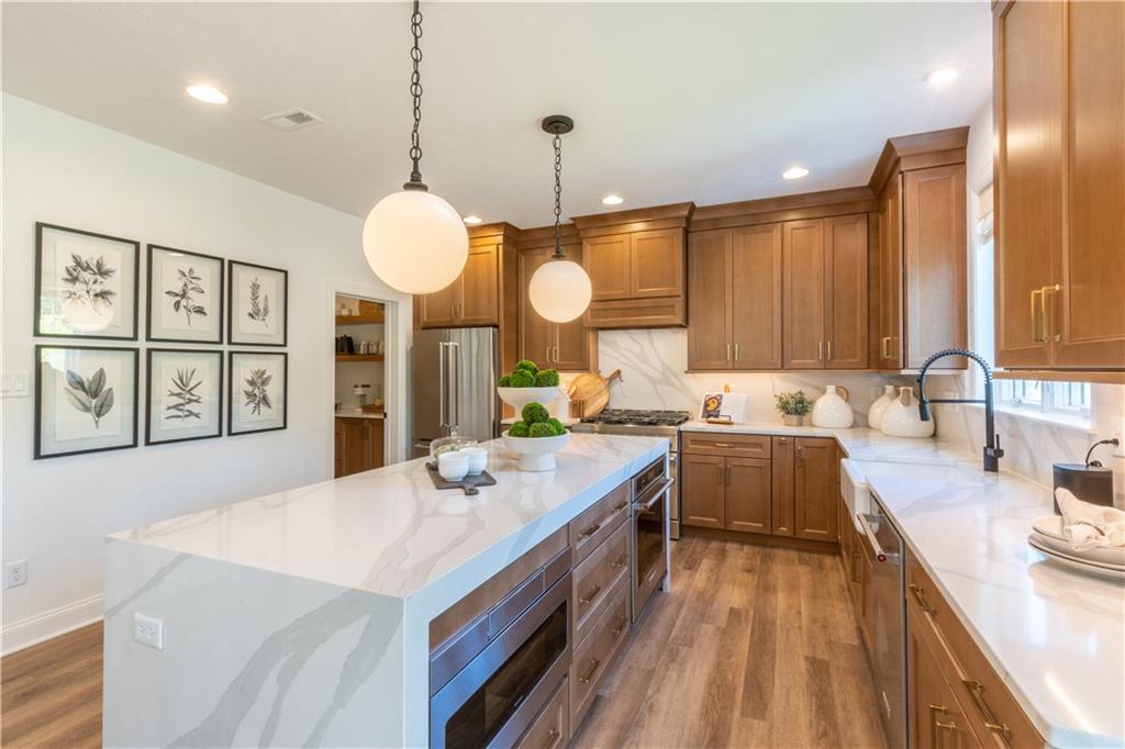 5136 Cline Hollow Road Export, PA 15632 - Photo 6 of 25 a large kitchen with kitchen island white cabinets and stainless steel appliances