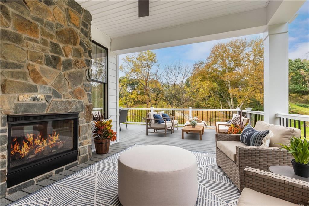 5136 Cline Hollow Road Export, PA 15632 - Photo 9 of 25 a living room with furniture a fireplace and a floor to ceiling window