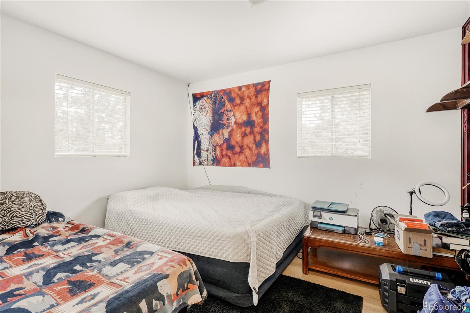 26207 South End Road Kittredge, CO 80457 - Photo 11 of 32 a bedroom with a bed and a table