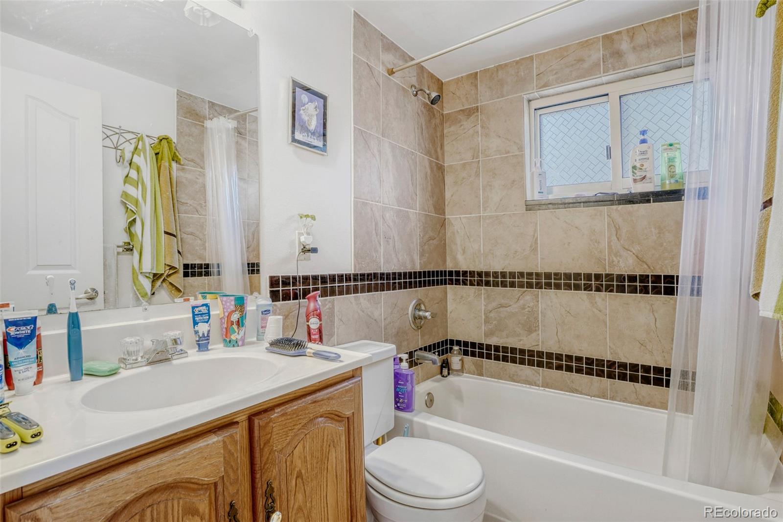 26207 South End Road Kittredge, CO 80457 - Photo 12 of 32 a bathroom with a granite countertop sink a toilet and shower