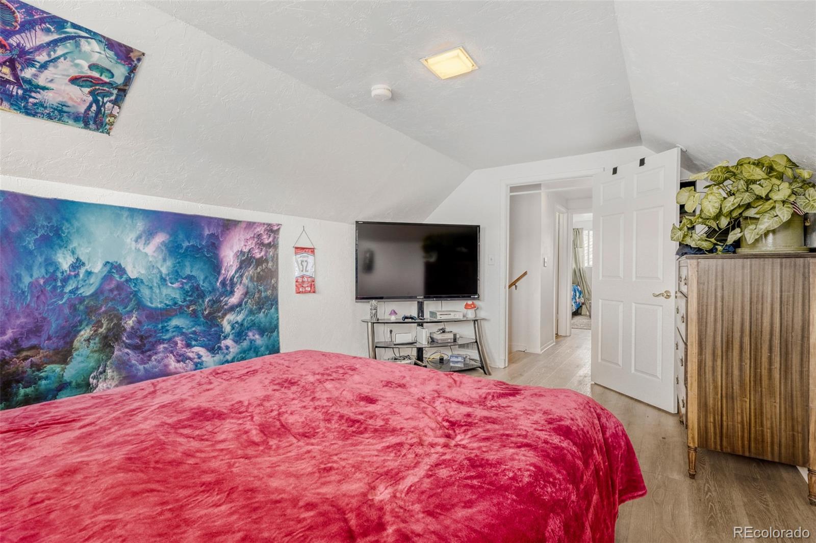 26207 South End Road Kittredge, CO 80457 - Photo 14 of 32 a bedroom with a bed and a flat screen tv