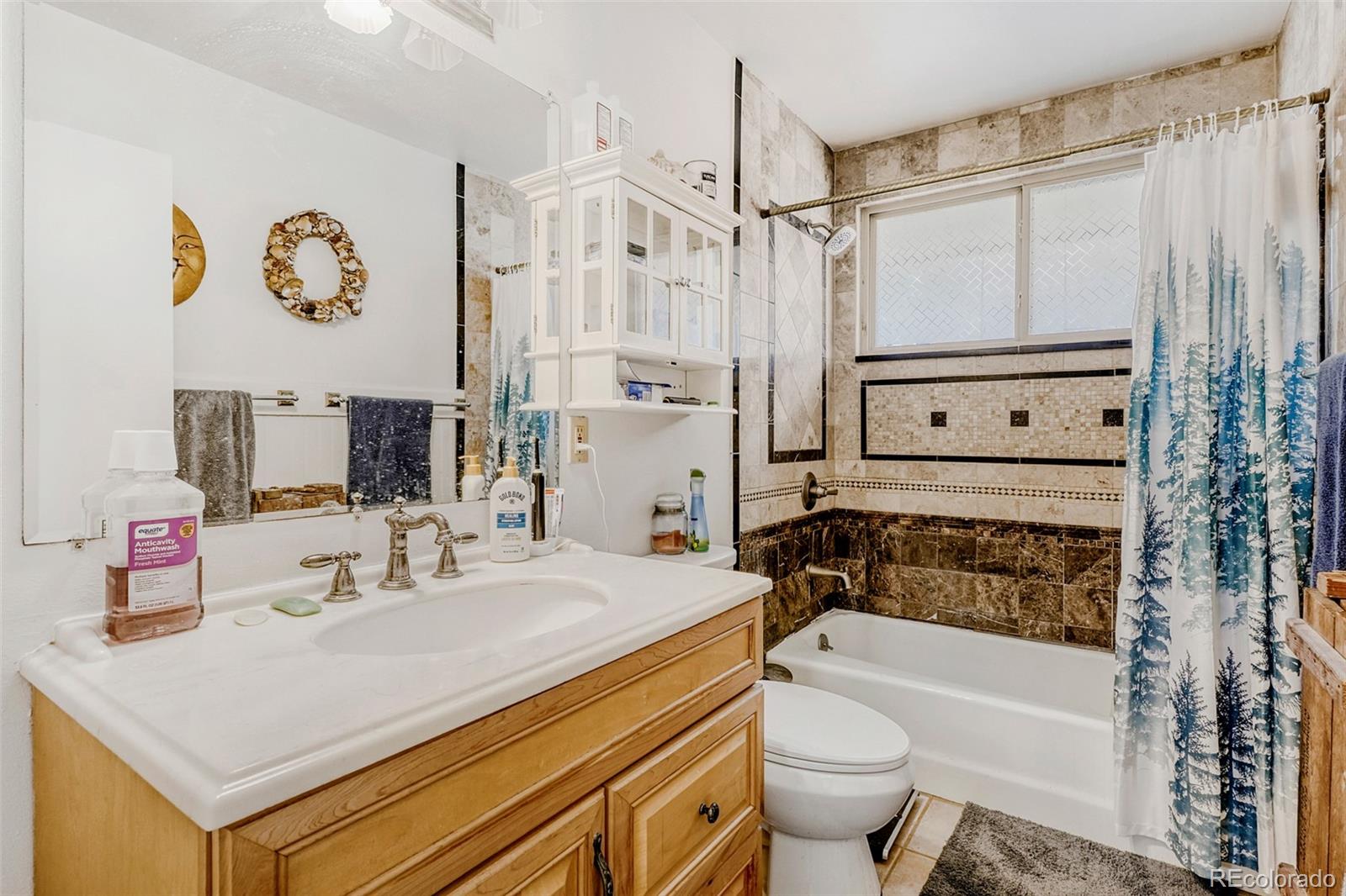 26207 South End Road Kittredge, CO 80457 - Photo 15 of 32 a bathroom with a sink a toilet and shower