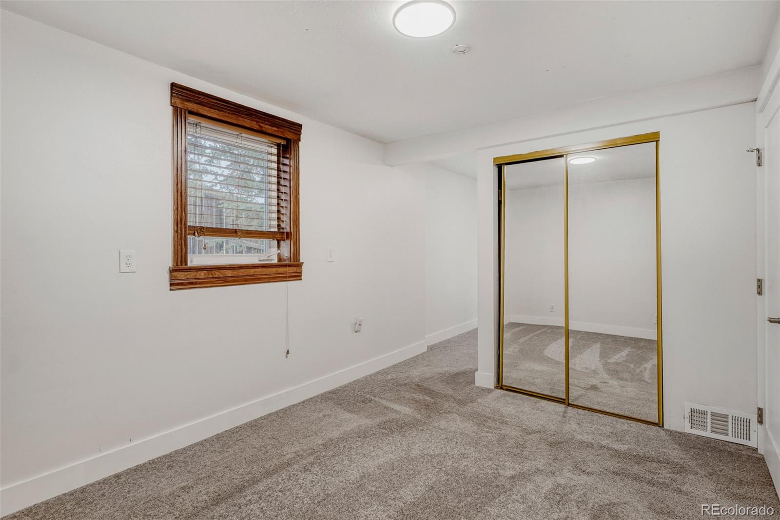 26207 South End Road Kittredge, CO 80457 - Photo 23 of 32 an empty room with windows