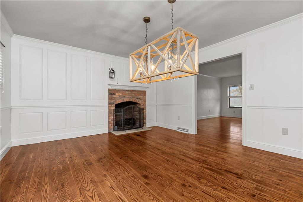 500 Davis School Road Washington, PA 15301 - Photo 16 of 48 an empty room with wooden floor fireplace and windows