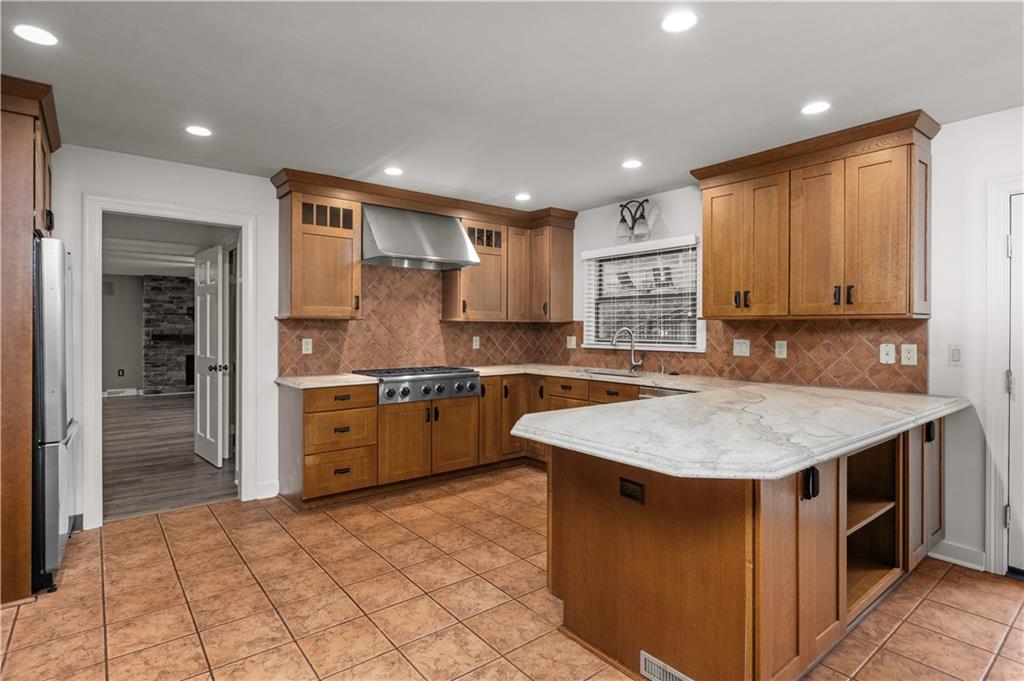500 Davis School Road Washington, PA 15301 - Photo 20 of 48 a kitchen with stainless steel appliances granite countertop a sink counter space cabinets and a large window