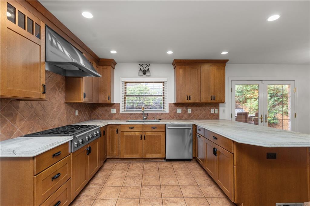 500 Davis School Road Washington, PA 15301 - Photo 22 of 48 a kitchen with stainless steel appliances granite countertop a sink a stove a refrigerator and island with wooden floor