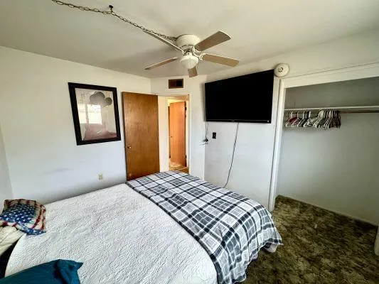 a bedroom with a bed and a flat screen tv