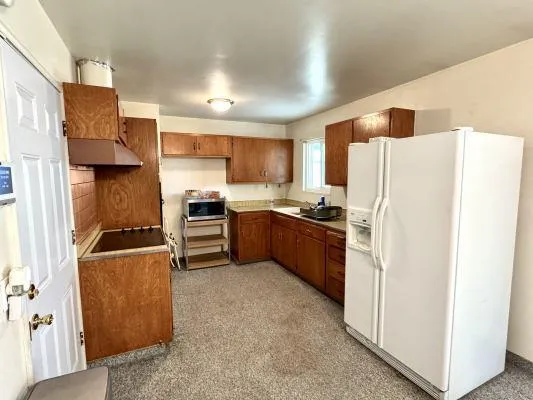a kitchen with stainless steel appliances a refrigerator and a stove top oven