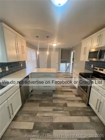 a kitchen with a stove a sink and a microwave