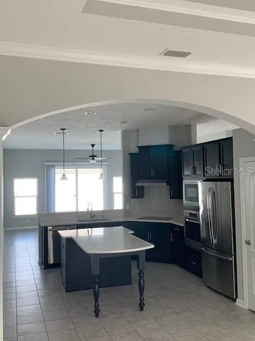 a stove top oven sitting inside of a kitchen