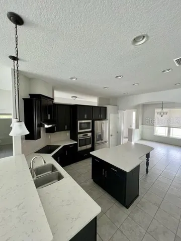 an empty room with a empty space and windows