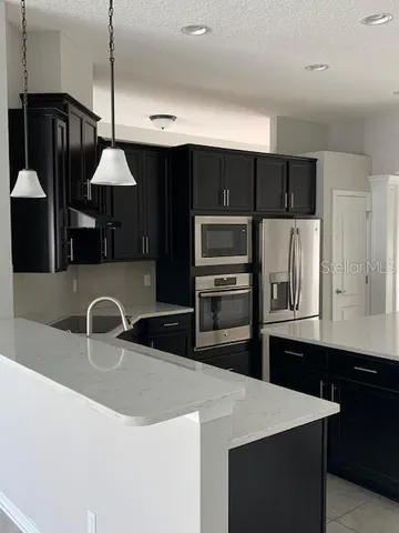 a room with pool table and a chandelier
